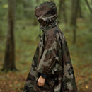 waterproof ripstop poncho in woodland camouflage person is in forest