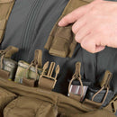 Close-up of Helikon-tex Guardian chest rig vest in Cordura with MOLLE straps holding tactical gear and magazines.
