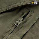 Close-up of olive green M-TAC military grade Bermuda shorts zipper with ripstop fabric texture.