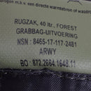 Close-up of Dutch military woodland camo daypack label showing 40-liter capacity and NSN number on textured fabric.