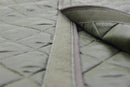 Close-up of olive green quilted liner with Velcro fastening designed for Swedish military parka jackets.