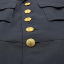 Close-up of a vintage Swedish army marines dress uniform jacket with gold anchor buttons and chest pockets.