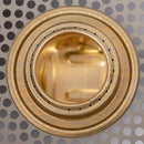 Close-up of the brass Trangia alcohol burner top showing fuel holes for efficient outdoor cooking heat distribution.