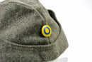 Close-up of WWII Swedish army winter wool side cap with blue and yellow roundel button on side