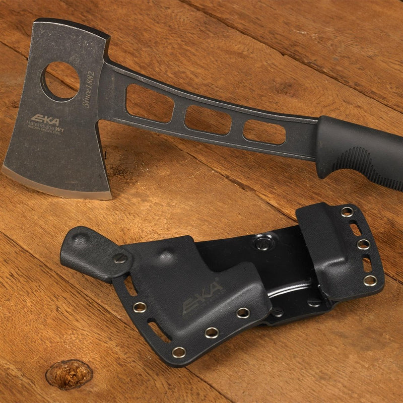 EKA HatchBlade W1 hand axe with black G10 handle and 12C27 steel head next to black Kydex sheath on wood background