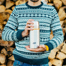Person wearing a patterned sweater holding a silver ESBIT vacuum flask with a wood log background