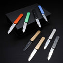 Set of compact folding knives with colorful handles and sharp stainless steel blades displayed on black surface.