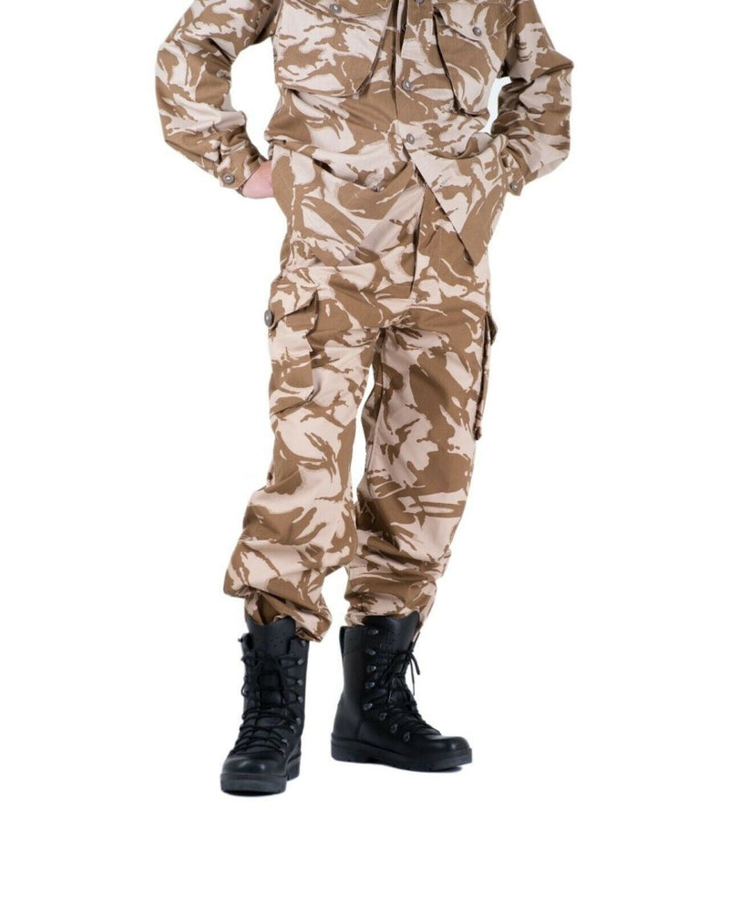 British army desert camouflage combat trousers paired with black military boots on white background.
