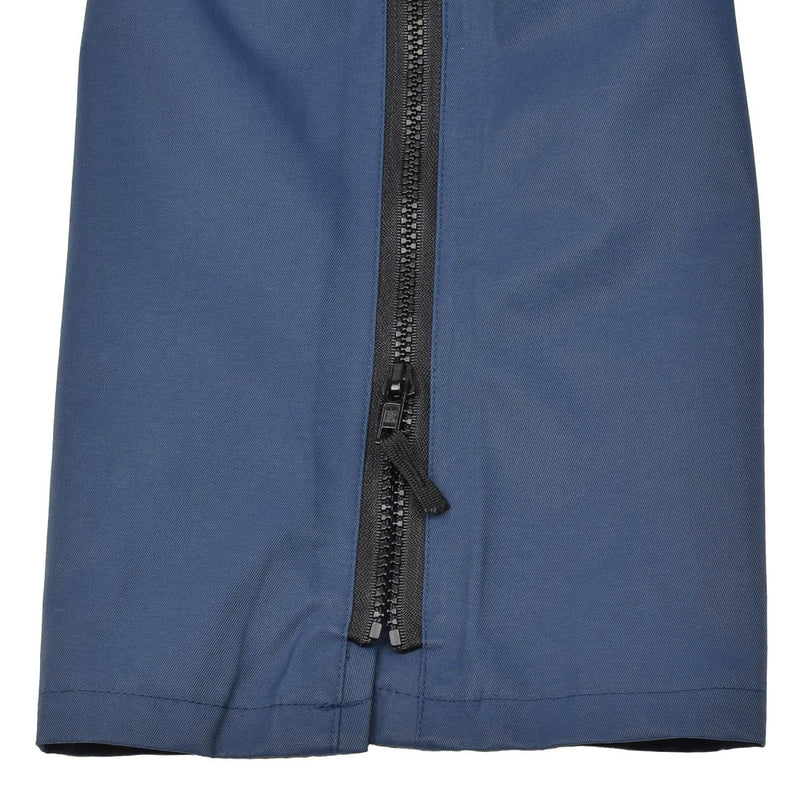 Close-up of blue waterproof British RAF MVP trousers showing a durable zipper and fabric detail