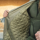 Close-up of the inside quilted lining of the Genuine Dutch Army Khaki trench coat held open by a person.