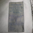 Close-up of a fabric label showing sizing and care instructions inside Genuine French Army FELIN combat pants.