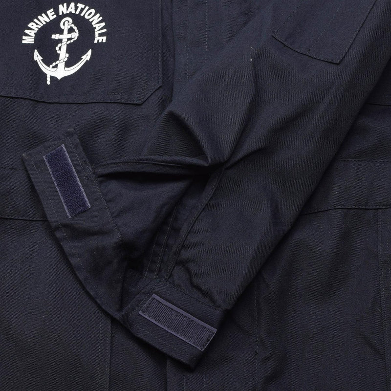 Close-up of dark blue French navy coverall sleeve with adjustable Velcro cuff and Marine Nationale anchor emblem embroidery