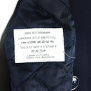 Close-up of the label inside a genuine Italian Carabinieri trench coat showing fabric and care details.