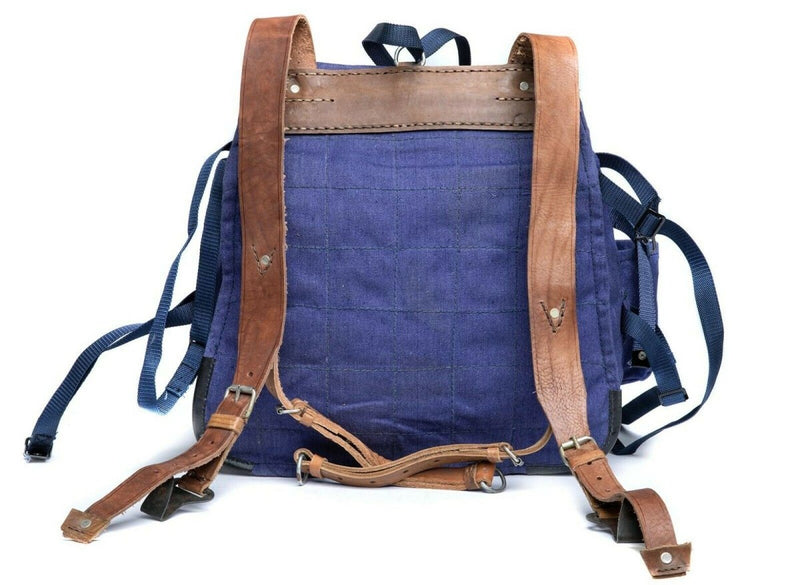 Genuine Romanian Army rucksack in blue canvas with worn leather straps, military surplus backpack for rugged use.