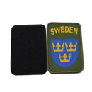 Sweden military patch with three golden crowns on blue shield and olive green background with SWEDEN text above.
