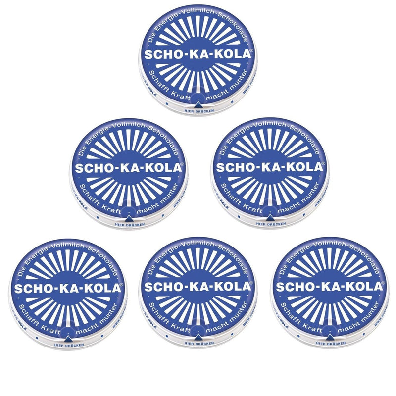 Five blue round tin cans of German Scho-Ka-Kola whole milk energy chocolate with white logo and text.