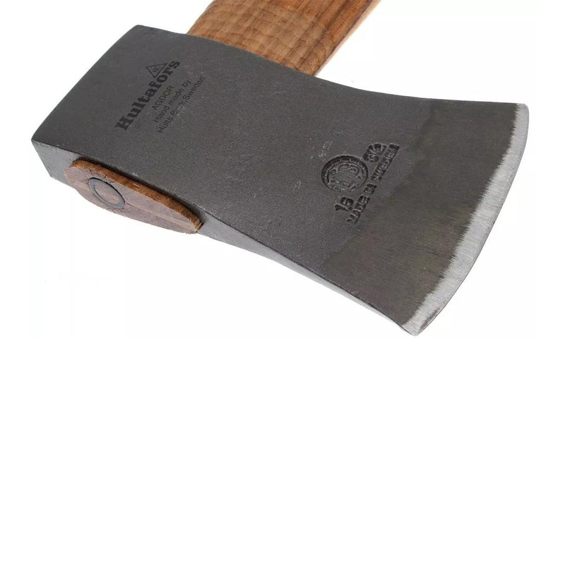 Close-up of HULTAFORS felling axe blade with durable carbon steel and wooden handle for outdoor use.