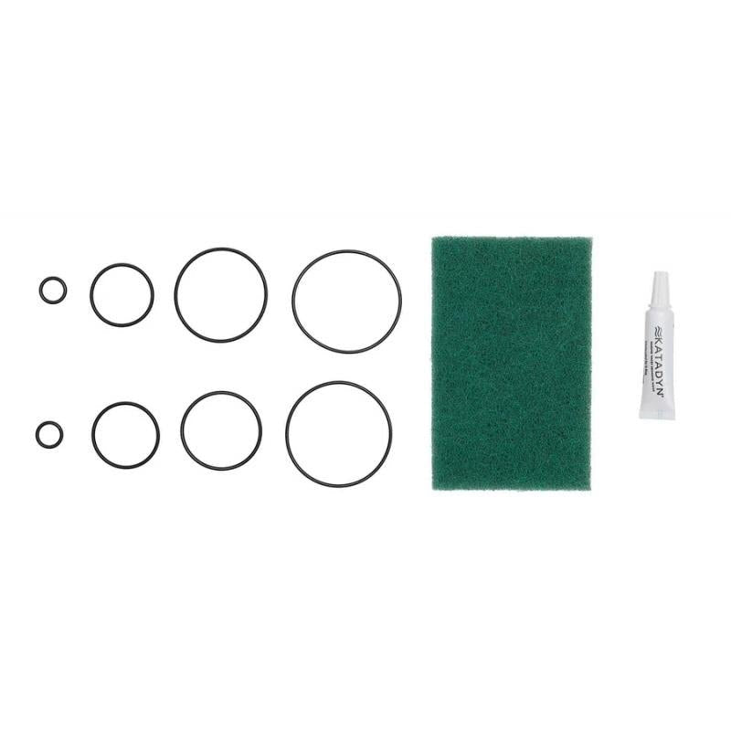 Katadyn Combi maintenance kit with 8 O-rings, silicone lubricant tube, and green cleaning pad for water filter upkeep.