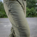 Close-up of olive green M-TAC military tactical pants with zipper pocket and reinforced stitching detail