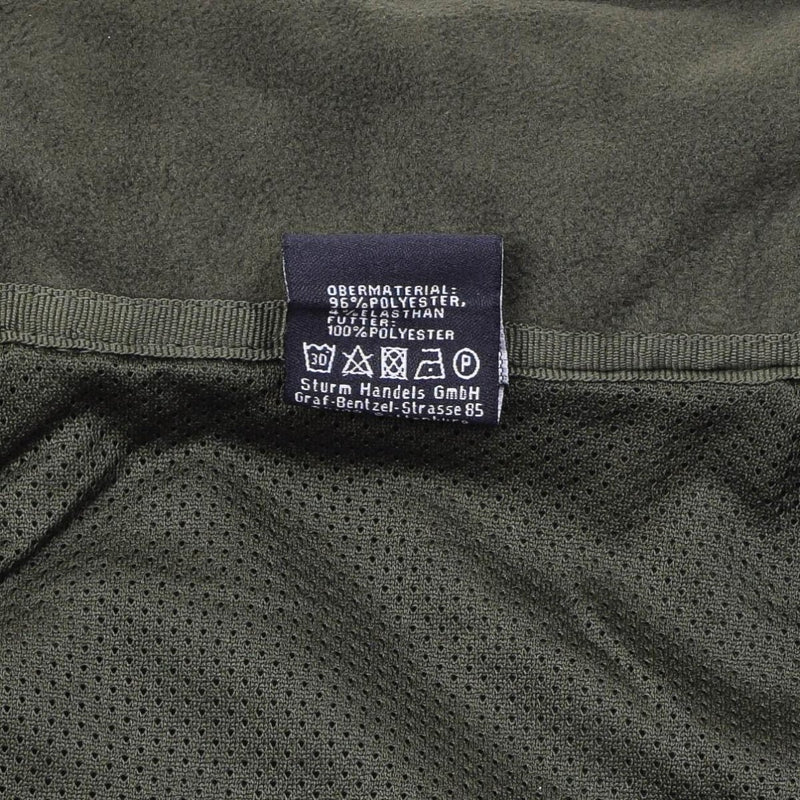 Care label inside MIL-TEC Flecktarn softshell jacket showing polyester material and washing instructions
