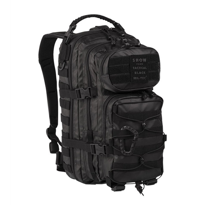 Black MIL-TEC U.S. Assault tactical backpack 20L with multiple compartments and adjustable padded straps for hiking, camping.