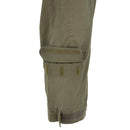 Close-up of olive green ripstop Austrian army coverall leg with adjustable hook and loop cuff and pocket flap details.