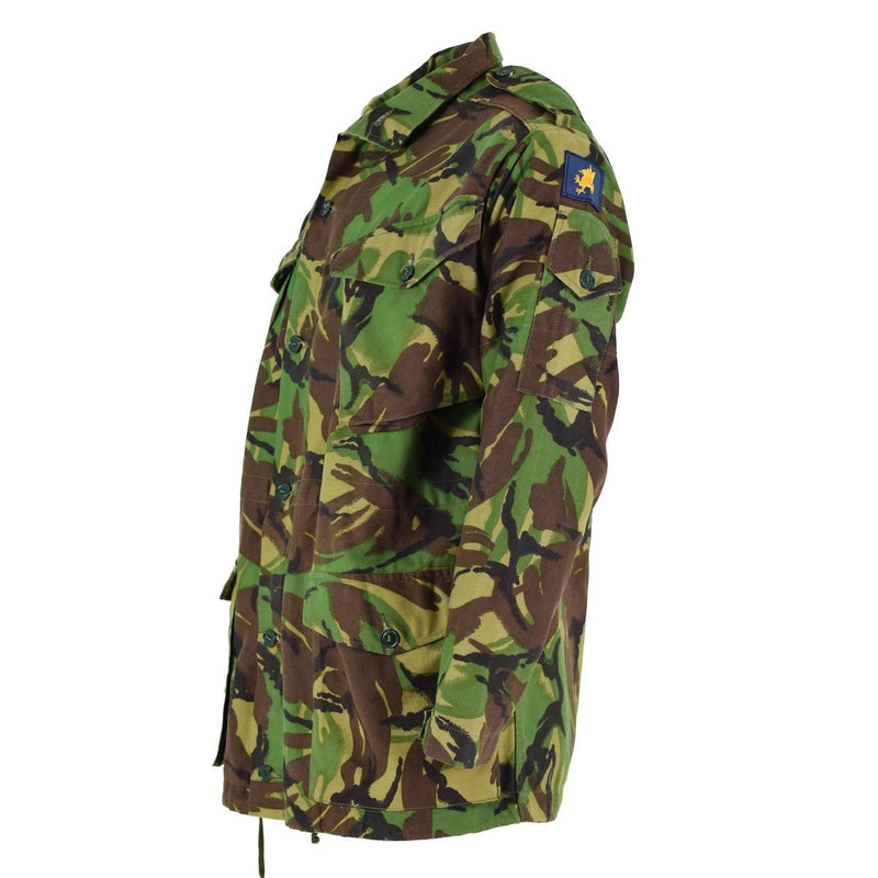 Original British army BDU combat smock jacket in woodland camo with multiple pockets and adjustable fit for cold weather use.