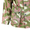 Close-up of Finnish M-62 army camo jacket sleeve and front pocket in green and brown reversible design