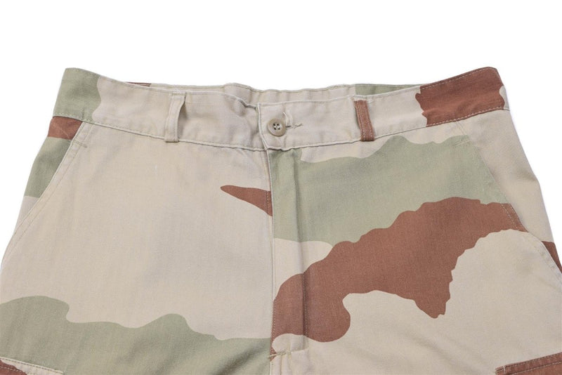 Close-up of original French military F2 desert camo pants showing reinforced fabric and camouflage pattern design