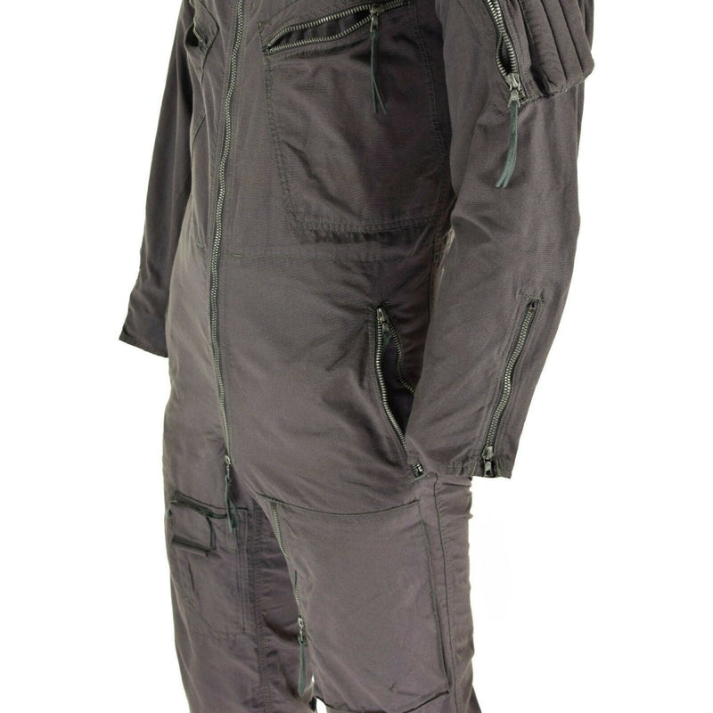Close-up of a dark German army cotton pilot coverall with zippered pockets and detailed stitching on sleeves and legs.