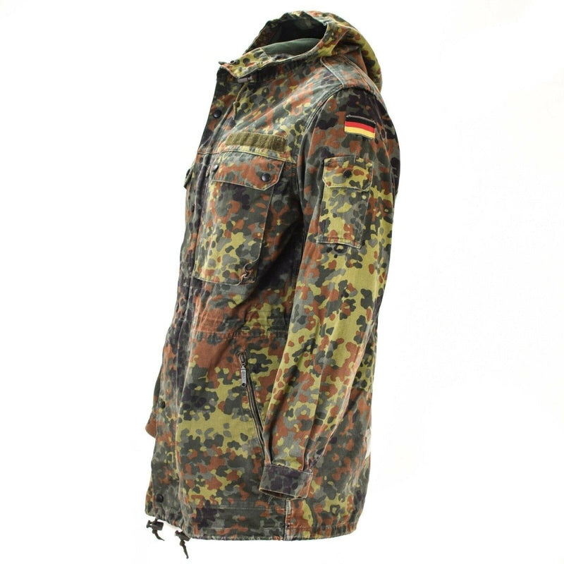 Original German army Flecktarn camouflage parka with hood, liner, multiple pockets, and German flag patch on sleeve.