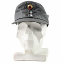 Original German army Gebirgsjäger grey mountain cap with flat top, peaked front, and metal buttons on white display bust.