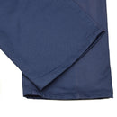 Close-up of blue Italian military work pants made of durable cotton with reinforced stitching.