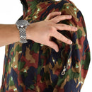 Close-up of a hand opening a zippered arm pocket on Swiss Alpenflage camouflage military coverall jacket sleeve