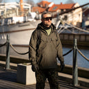 Man wearing SWISS EYE full frame tactical goggles with UV protection by the waterfront on a sunny day