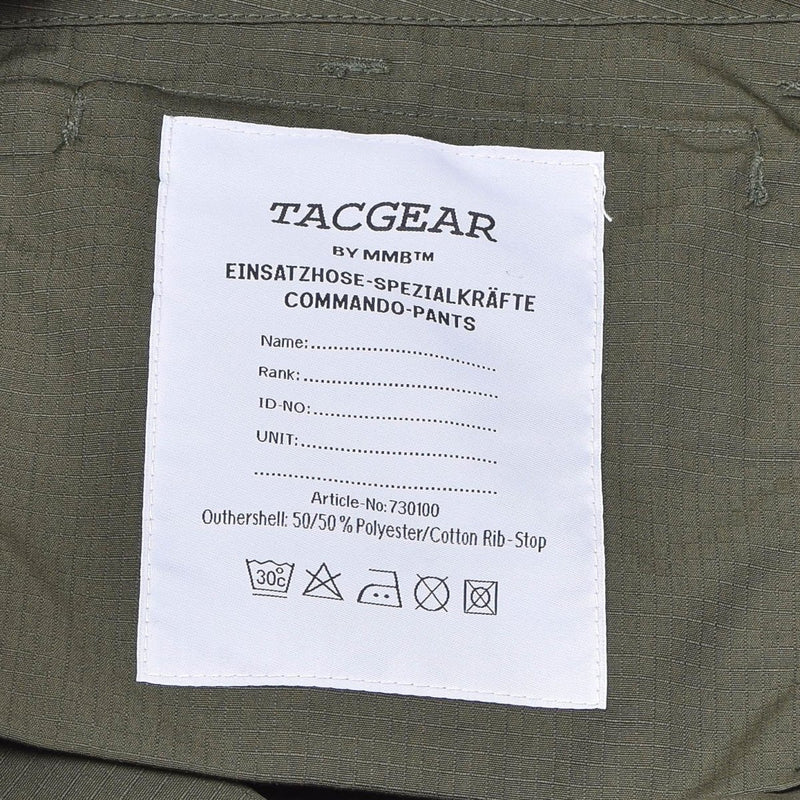 Close-up of TACGEAR olive ripstop cargo pants label showing material and care instructions.