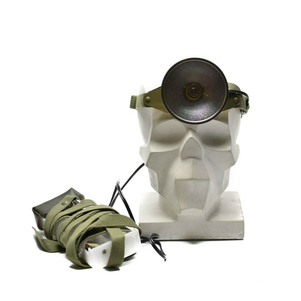 Skull with headlamp with green strap on a white background
