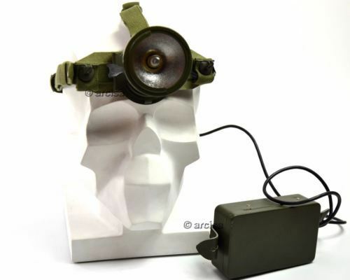 Green head lamp with a power supply on a white background